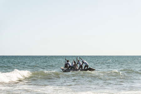 Salvador, Bahia, Brazil - January 20, 2019: Fishermen inside canoes at sea paddling against the tide in celebration of IemanjÃ¡. Boca do Rio beach in Salvador, Bahia, Brazil.のeditorial素材