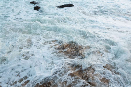 Sea waves from Praia do Rio Vermelho breaking on the clear sands. Salvador, Bahia, Brazil.