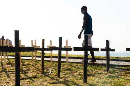 Salvador, Bahia, Brazil - October 01, 2021: Crosses fixed to the ground in honor of those killed by Covid-19 at Farol da Barra in Salvador, Bahia, Brazil.のeditorial素材