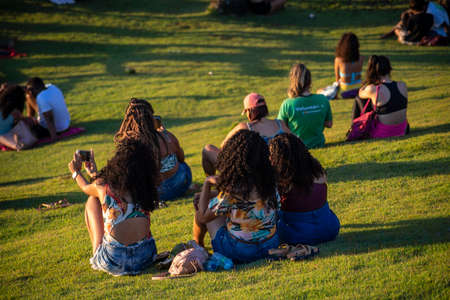 Salvador, Bahia, Brazil - September 19, 2021: Large group of people on the mountain enjoying the sunset at Barra beach in Salvador city, Bahia, Brazil.のeditorial素材