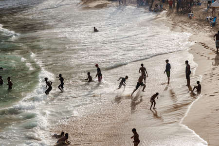 Salvador, Bahia, Brazil - August 22, 2021: Large group of people on Paciencia beach in the Rio Vermelho neighborhood of Salvador, Brazil. People having fun in the middle of the coronavirus pandemic.のeditorial素材