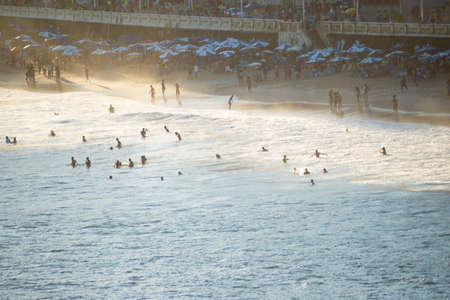 Salvador, Bahia, Brazil - September 19, 2021: Large group of people on the beach in a bright sunny...