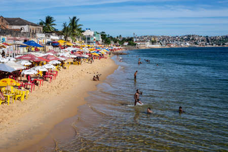 Salvador, Bahia, Brazil - December 31, 2021: Bathers on Boa Viagem beach enjoying the strong sun in Salvador city, Bahia, Brazil.のeditorial素材