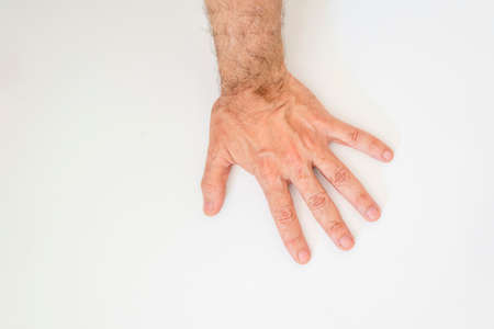 Close-up of a light-colored hand on a white background. Salvador, Bahia, Brazil.