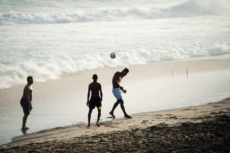 Salvador, Bahia, Brazil - September 26, 2021: Young people playing beach soccer at Farol da Barra beach in Salvador, Bahia state, Brazil.のeditorial素材
