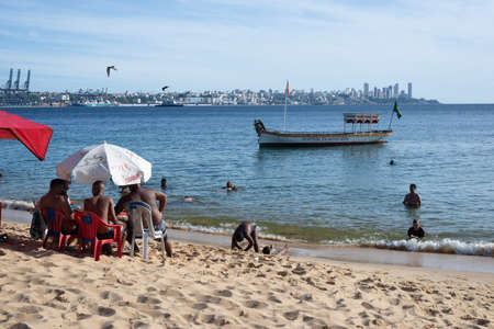 Salvador, Bahia, Brazil - December 31, 2021: Bathers on Boa Viagem beach enjoying the strong sun in Salvador city, Bahia, Brazil.のeditorial素材