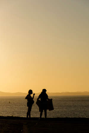 Silhouette of group of people against the sunset. Salvador, Bahia, Brazil.のeditorial素材