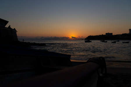 Dramatic sunset on the beach with vibrant colors. Salvador, Bahia, Brazil.