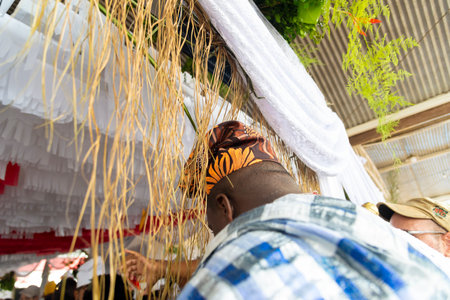 Santo Amaro, Bahia, Brazil - May 15, 2022: Members of the Candomble religion are seen during a religious celebration in a terreiro in the city of Santo Amaro da PurificaÃ§Ã£o in Bahia, Brazil.のeditorial素材