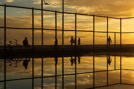 Sports court silhouette against dramatic orange sunset. City of Salvador, Bahia, Brazil.のeditorial素材