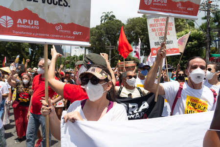 Salvador, Bahia, Brazil - October 02, 2021: Brazilians protest with banners and posters against the government of President Jair Bolsonaro in the city of Salvador.のeditorial素材