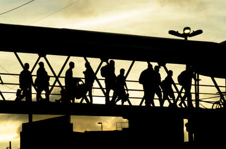 Salvador, Bahia, Brazil - January 26, 2015: Pedestrians in silhouette walking on walkway against sunset in Salvador city, capital of Bahia, Brazil.のeditorial素材