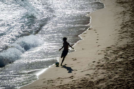 Salvador, Bahia, Brazil - November 01, 2021: People at PaciÃªncia beach in Salvador having fun walking and playing beach soccer.のeditorial素材