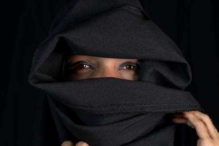 Portrait of a woman wearing hijab against black background. Salvador, Bahia, Brazil.の写真素材