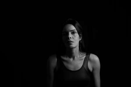 Black and white portrait of a woman against black background. Salvador, Bahia, Brazil.の写真素材