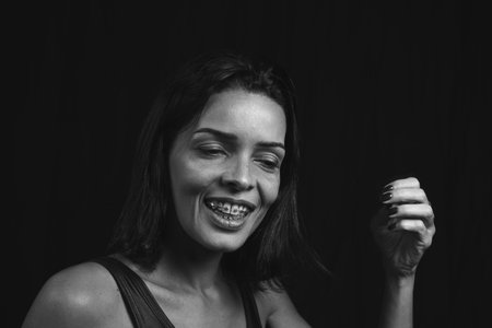 Black and white portrait of a woman against black background. Salvador, Bahia, Brazil.の写真素材