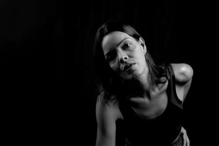 Black and white portrait of a woman against black background. Salvador, Bahia, Brazil.