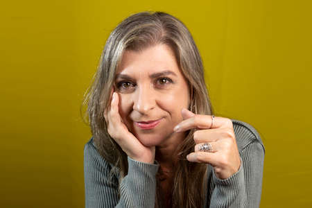 Portrait of a woman against yellow background. Salvador Bahia Brazil.の写真素材