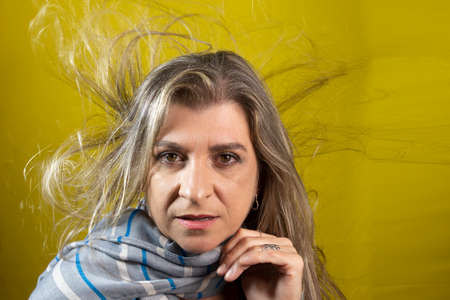 Portrait of a woman against yellow background. Salvador Bahia Brazil.の写真素材