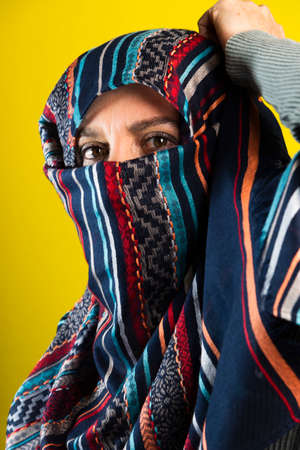 Portrait of a woman wearing hijab against black background. Salvador, Bahia, Brazil.の写真素材