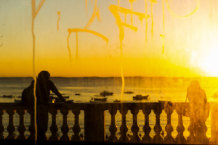Salvador, Bahia, Brazil - May 21, 2021: Silhouette of people at sunset with dramatic. City of Salvador, Bahia, Brazil.の写真素材