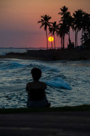 Salvador, Bahia, Brazil - October 06, 2020: Silhouette of people at sunset with dramatic. City of Salvador, Bahia, Brazil.の写真素材