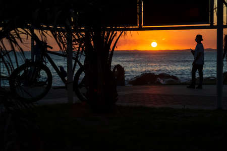 Salvador, Bahia, Brazil - October 21, 2020: Silhouette of people at sunset with dramatic. City of Salvador, Bahia, Brazil.の写真素材