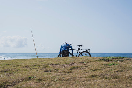 Salvador, Bahia, Brazil - October 10, 2021: Fisherman and his bike getting ready for fishing at Boca do Rio beach In Salvador, Bahia, Brazil.のeditorial素材