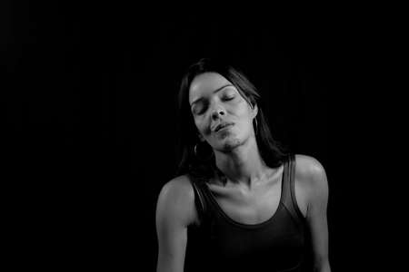 Black and white portrait of a woman against black background. Salvador, Bahia, Brazil.の写真素材