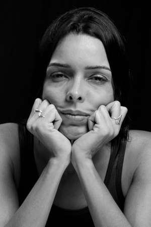 Black and white portrait of a woman against black background. Salvador, Bahia, Brazil.の写真素材