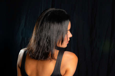 Portrait of a woman against black background. Salvador, Bahia, Brazil.の写真素材
