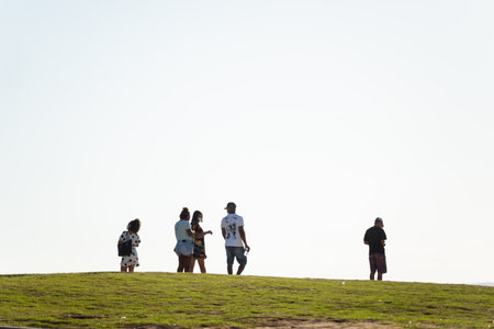 Salvador, Bahia, Brazil - May 21, 2021: People having fun on a grass floor in Barra neighborhood in Salvador, Bahia.のeditorial素材