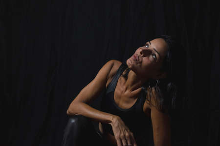Portrait of a woman against black background. Salvador, Bahia, Brazil.の写真素材