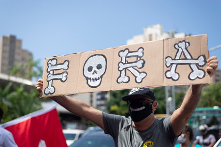 Salvador, Bahia, Brazil - October 02, 2021: People protesting with banners, posters and screams at the event against the government of President Bolsonaro, in Salvador, Bahia.のeditorial素材