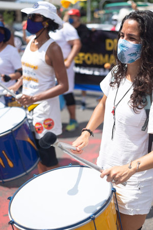 Salvador, Bahia, Brazil - October 02, 2021: People protesting with percussion instruments at the event against President Bolsonaro government, in Salvador, Bahia.のeditorial素材