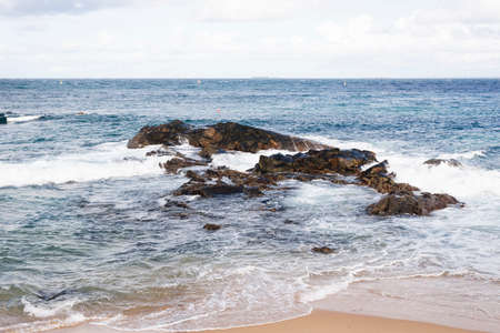 View of the sea breaking on the beach. Salvador, Bahia, Brazil.の写真素材