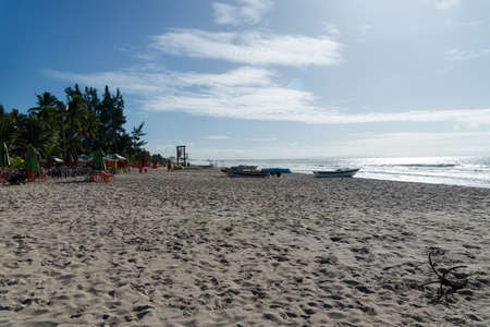 Clear and dense sand against blue sky with clouds and strong sun on Guaibim beach in Valenca city in Bahia, Brazil.の写真素材