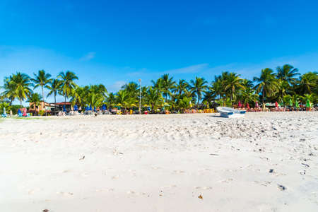 Clear and dense sand against blue sky with clouds and strong sun on Guaibim beach in Valenca city in Bahia, Brazil.の写真素材
