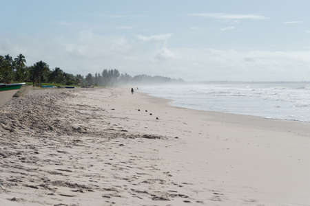 Clear and dense sand against blue sky with clouds and strong sun on Guaibim beach in Valenca city in Bahia, Brazil.の写真素材