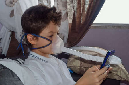 Child with fogging mask on his face playing game. Salvador, Bahia, Brazil.