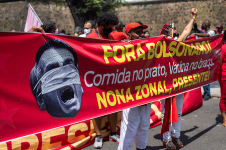 Salvador, Bahia, Brazil - October 02, 2021: Protester carries banner during demonstration against President Jair Bolsonaro in the city of Salvador.のeditorial素材