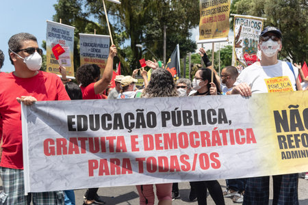 Salvador, Bahia, Brazil - October 02, 2021: Protester carries a flag during a demonstration against President Jair Bolsonaro in the city of Salvador.のeditorial素材
