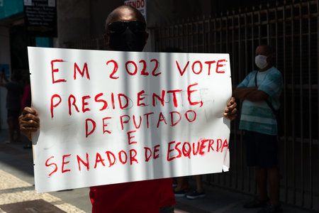 Salvador, Bahia, Brazil - October 02, 2021: Protester carries a poster during a demonstration against President Jair Bolsonaro in the city of Salvador.のeditorial素材