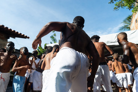 Santo Amaro, Bahia, Brazil - July 24, 2022: Members of the cultural event Nego Fugido dance and sing in a group for the end of slavery in Acupe, Santo Amaro, Bahia.のeditorial素材