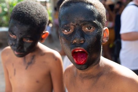 Santo Amaro, Bahia, Brazil - July 24, 2022: Members of the cultural event Nego Fugido show their mouth with blood for a performance in Acupe, Santo Amaro, Bahia.のeditorial素材