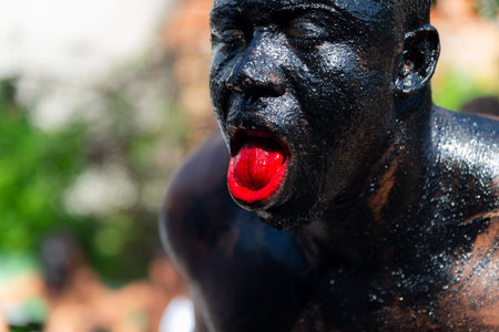 Santo Amaro, Bahia, Brazil - July 24, 2022: Members of the cultural event Nego Fugido show their mouth with blood for a performance in Acupe, Santo Amaro, Bahia.のeditorial素材