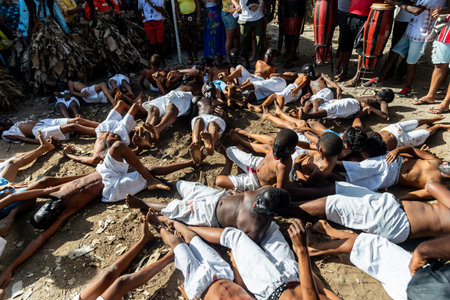 Santo Amaro, Bahia, Brazil - July 24, 2022: Members of the cultural manifestation Nego Fugido lying on the ground for the end of slavery in Acupe, Santo Amaro, Bahia.のeditorial素材