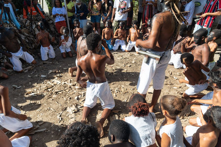 Santo Amaro, Bahia, Brazil - July 24, 2022: Members of the cultural event Nego Fugido dance and sing in a group for the end of slavery in Acupe, Santo Amaro, Bahia.のeditorial素材