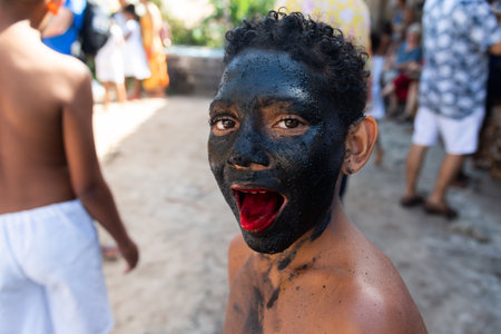 Santo Amaro, Bahia, Brazil - July 24, 2022: Members of the cultural event Nego Fugido show their mouth with blood for a performance in Acupe, Santo Amaro, Bahia.のeditorial素材
