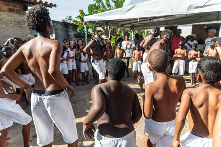 Santo Amaro, Bahia, Brazil - July 24, 2022: Members of the cultural event Nego Fugido dance and sing in a group for the end of slavery in Acupe, Santo Amaro, Bahia.のeditorial素材